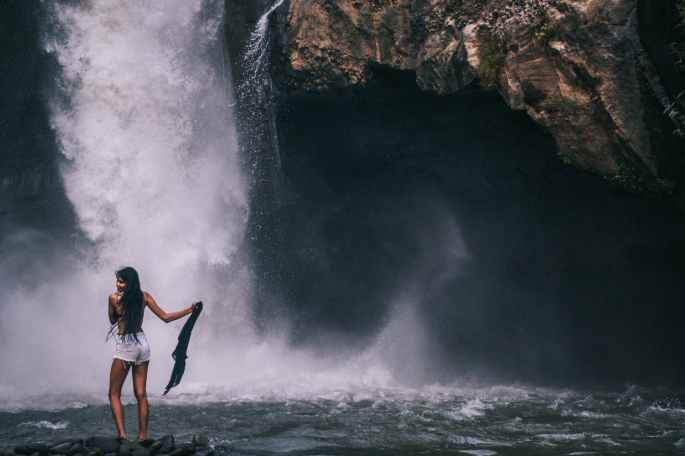 woman standing near waterfalls