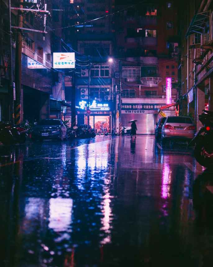 person under umbrella walking on street
